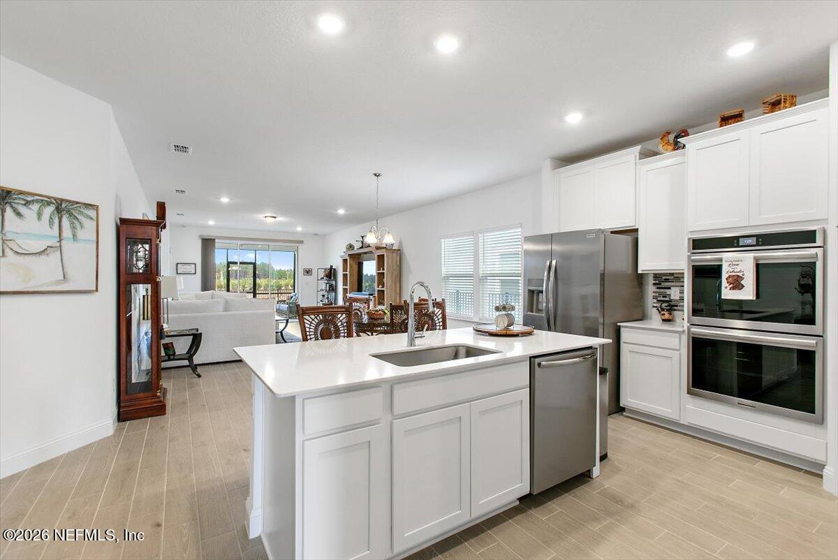 100 Simonson Run St. Augustine, FL 32092 - Photo 11 of 30 a kitchen with a sink stainless steel appliances and cabinets