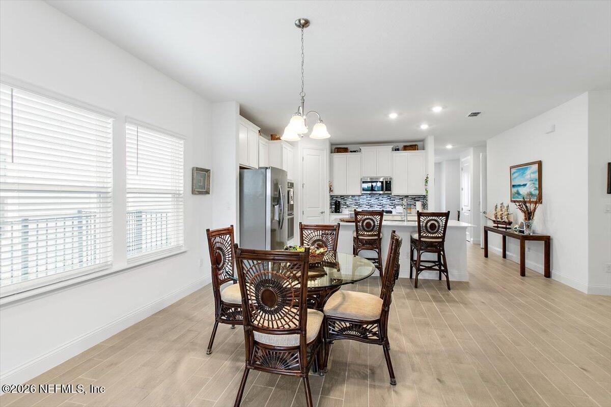 100 Simonson Run St. Augustine, FL 32092 - Photo 12 of 30 a view of a dining room with furniture window and wooden floor