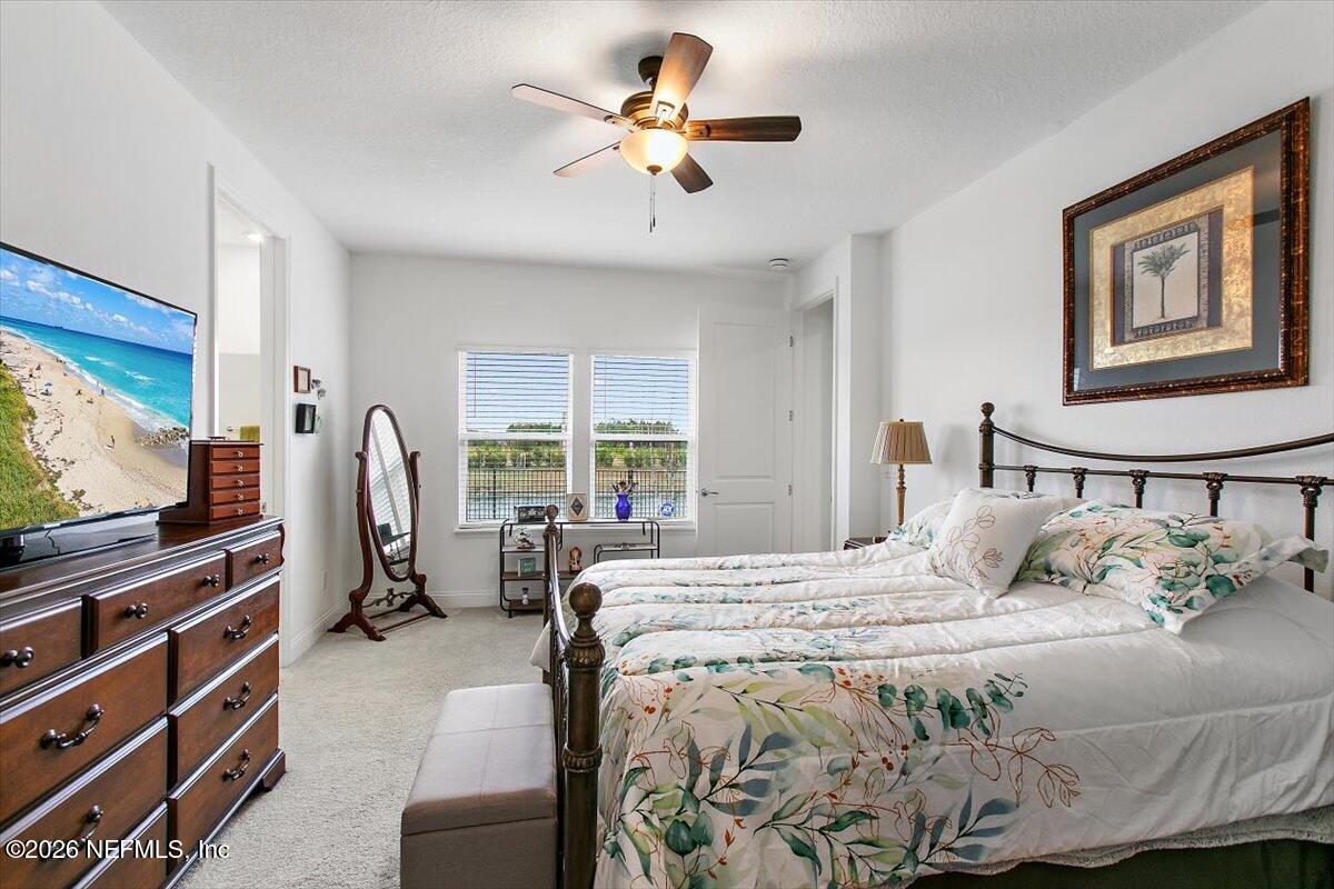 100 Simonson Run St. Augustine, FL 32092 - Photo 17 of 30 a bedroom with a bed and a flat screen tv