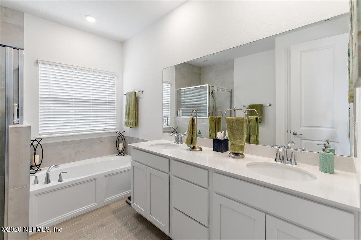 100 Simonson Run St. Augustine, FL 32092 - Photo 18 of 30 a bathroom with a bathtub a double vanity sink and mirror