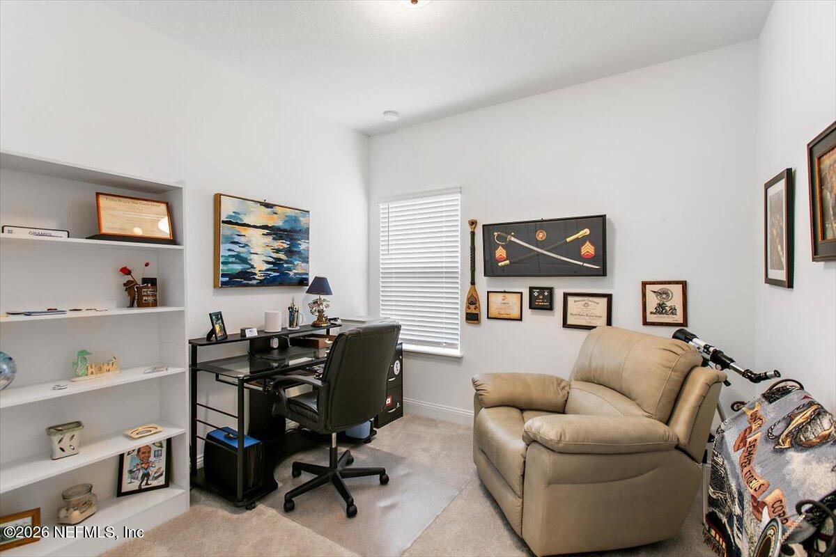 100 Simonson Run St. Augustine, FL 32092 - Photo 20 of 30 a livingroom with workspace and a couch