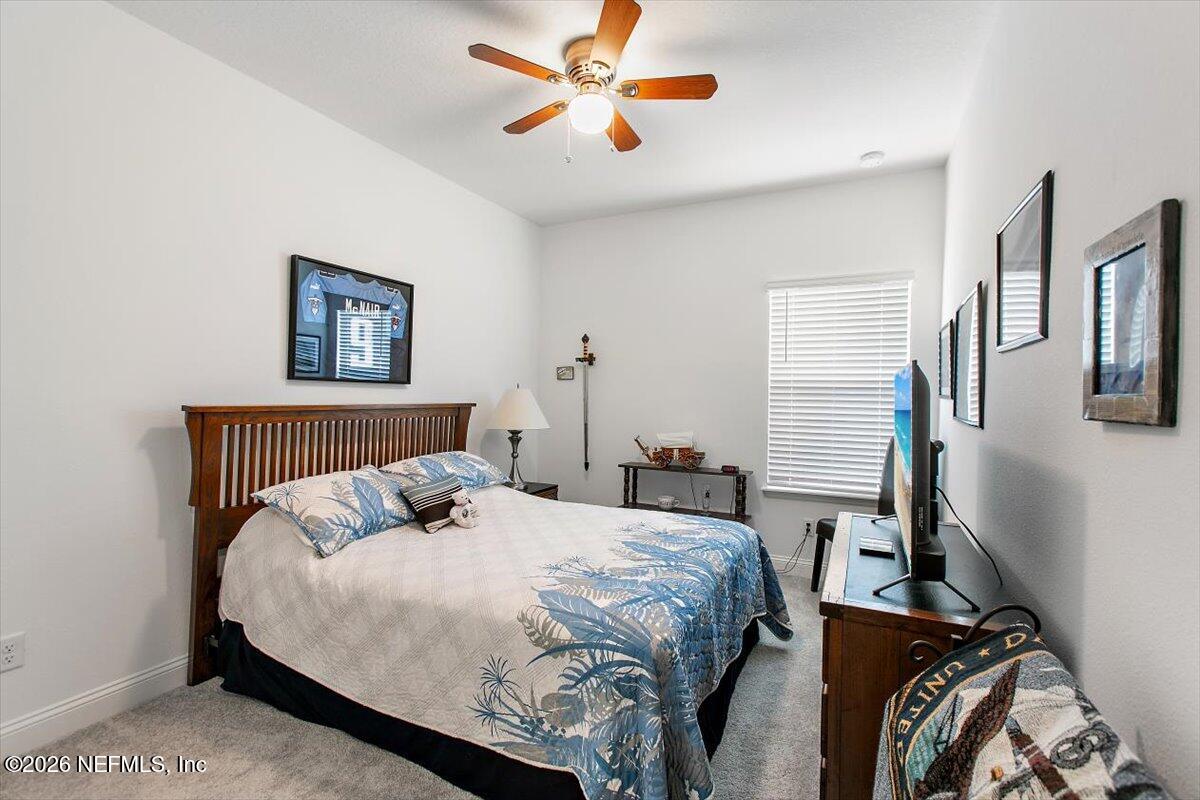 100 Simonson Run St. Augustine, FL 32092 - Photo 23 of 30 a bedroom with bed and a chandelier