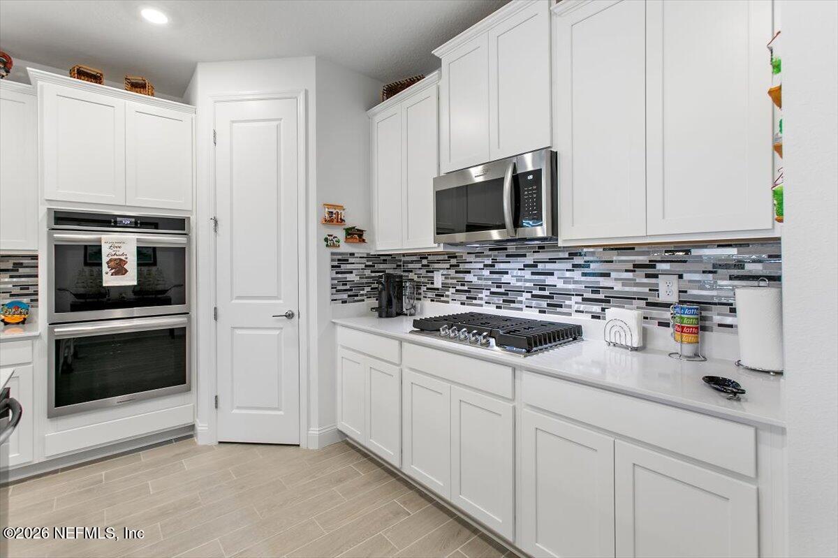 100 Simonson Run St. Augustine, FL 32092 - Photo 9 of 30 a kitchen with sink a microwave and refrigerator