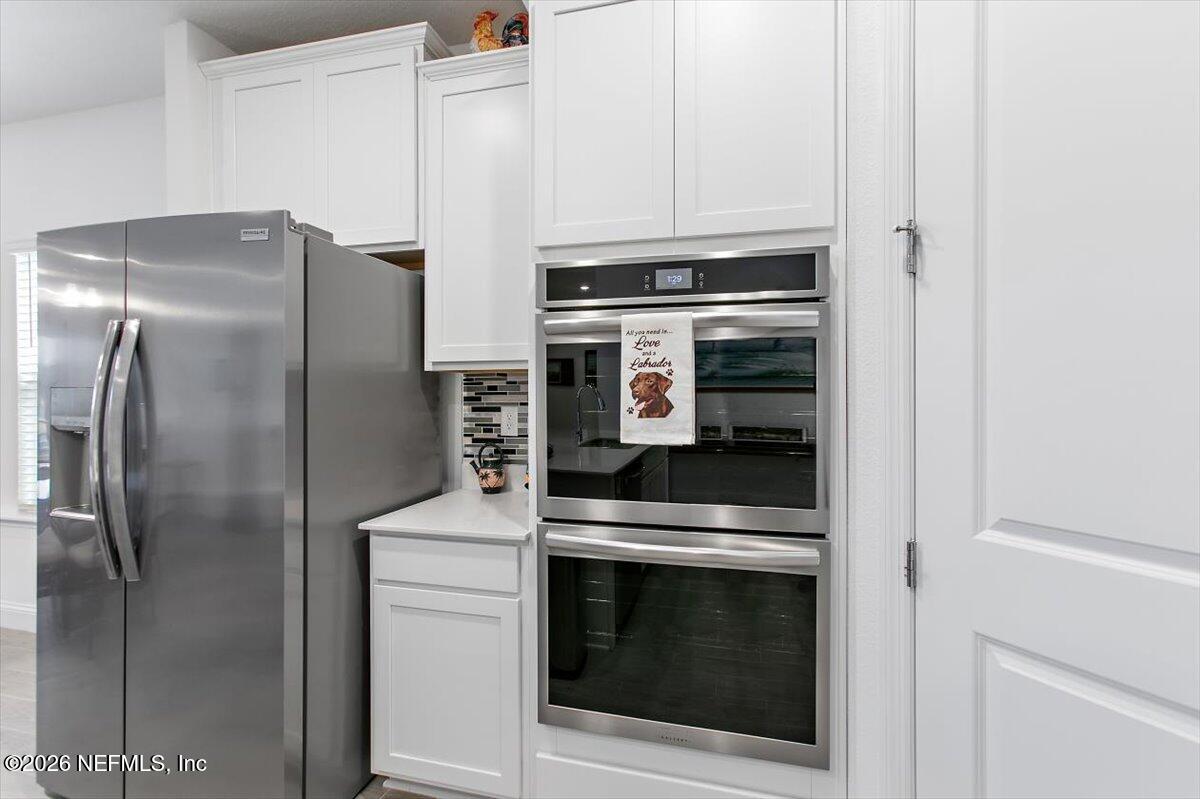 100 Simonson Run St. Augustine, FL 32092 - Photo 10 of 30 a kitchen with cabinets and stainless steel appliances
