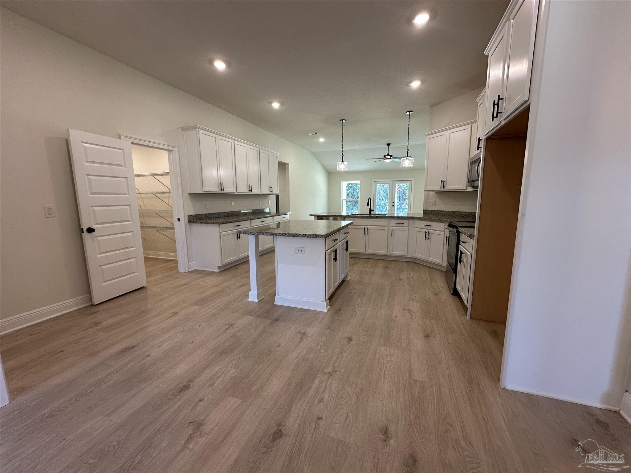 5223 Wahoo Road Milton, FL 32583 - Photo 12 of 26 a kitchen with stainless steel appliances a refrigerator and a stove top oven