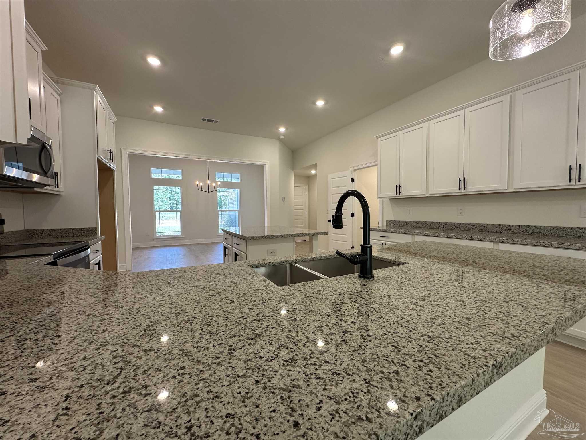 5223 Wahoo Road Milton, FL 32583 - Photo 13 of 26 a kitchen with sink and refrigerator