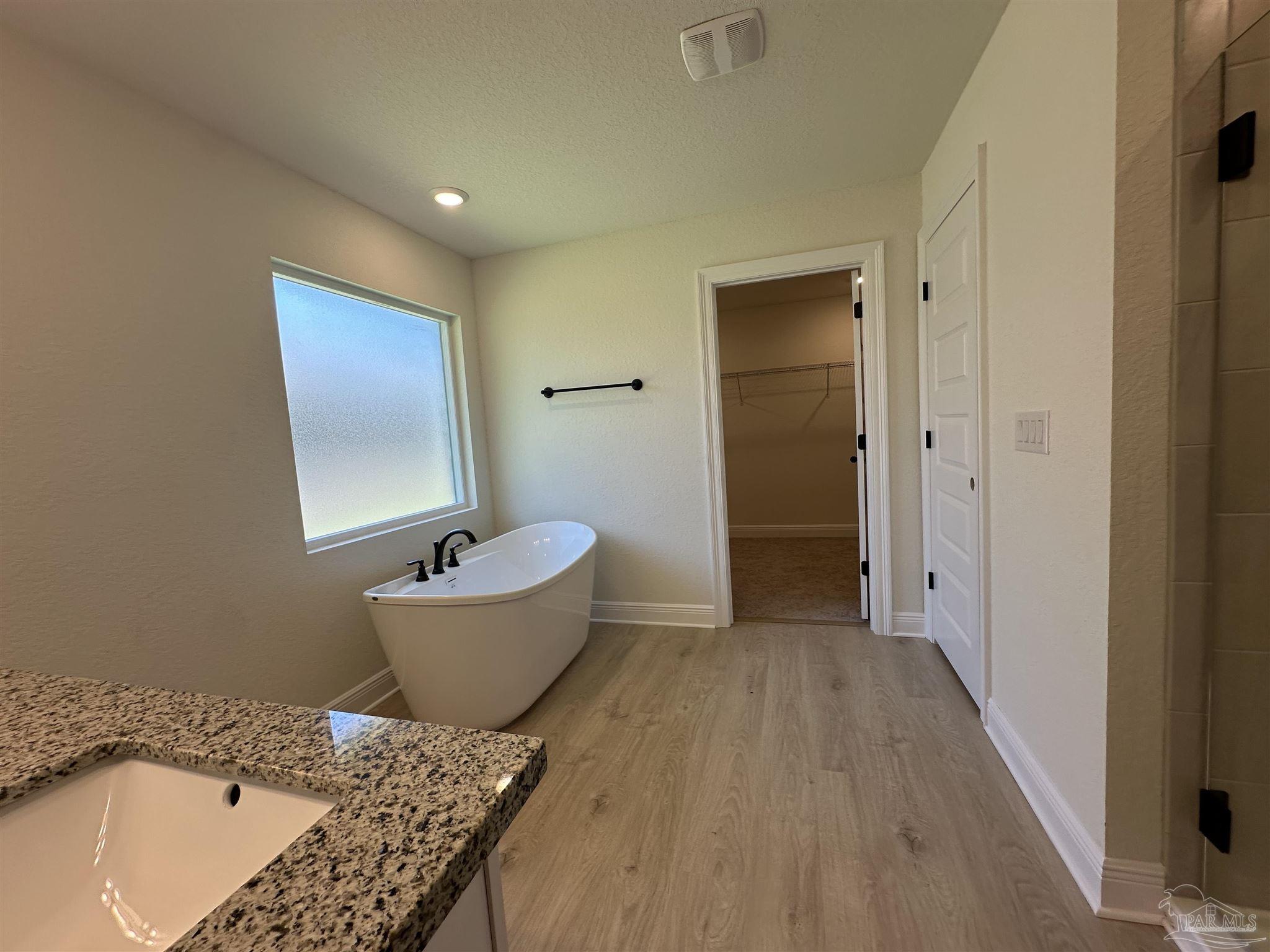 5223 Wahoo Road Milton, FL 32583 - Photo 18 of 26 a bathroom with a tub and a sink