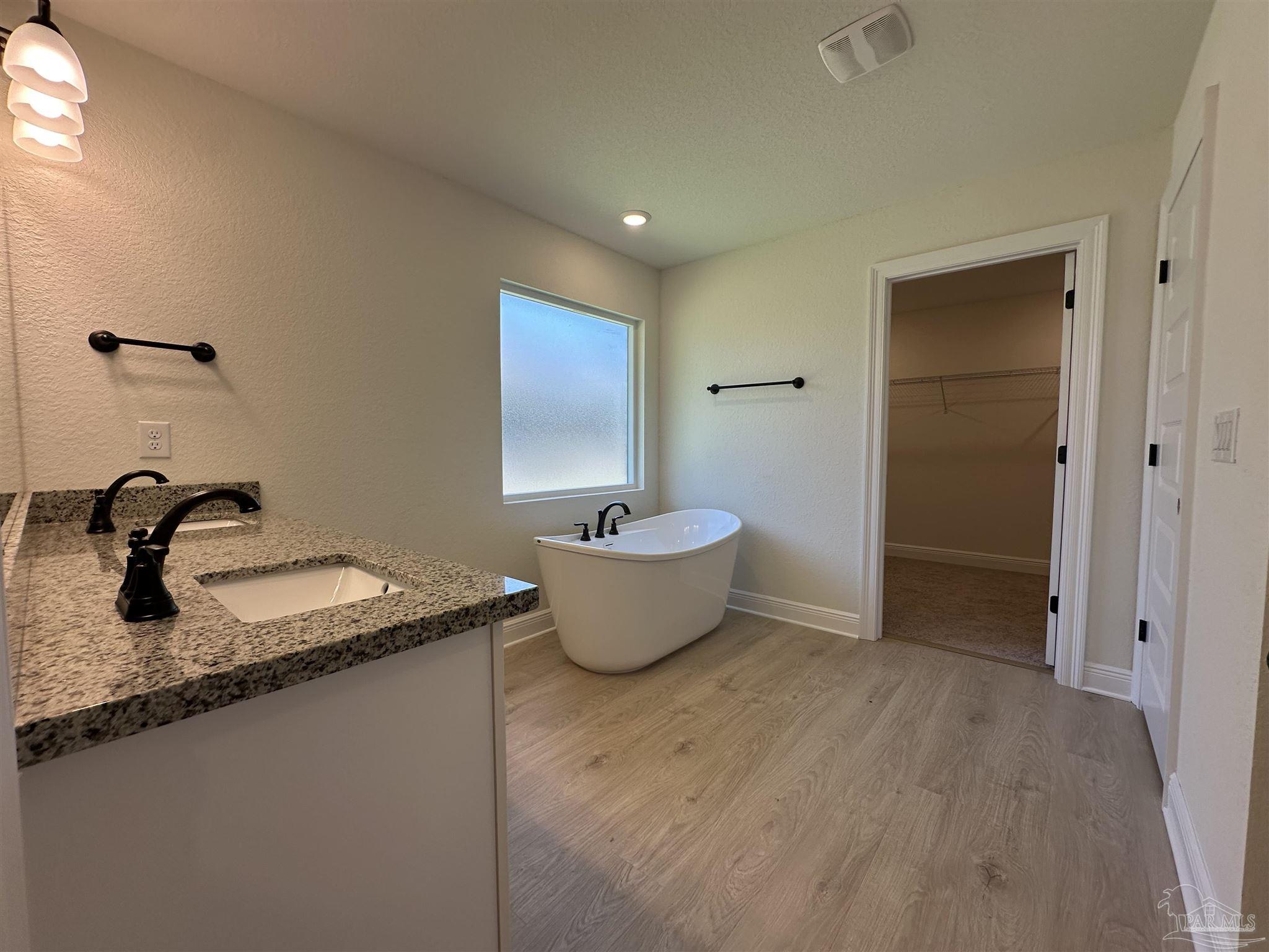 5223 Wahoo Road Milton, FL 32583 - Photo 22 of 26 a bathroom with a granite countertop sink a toilet and a mirror