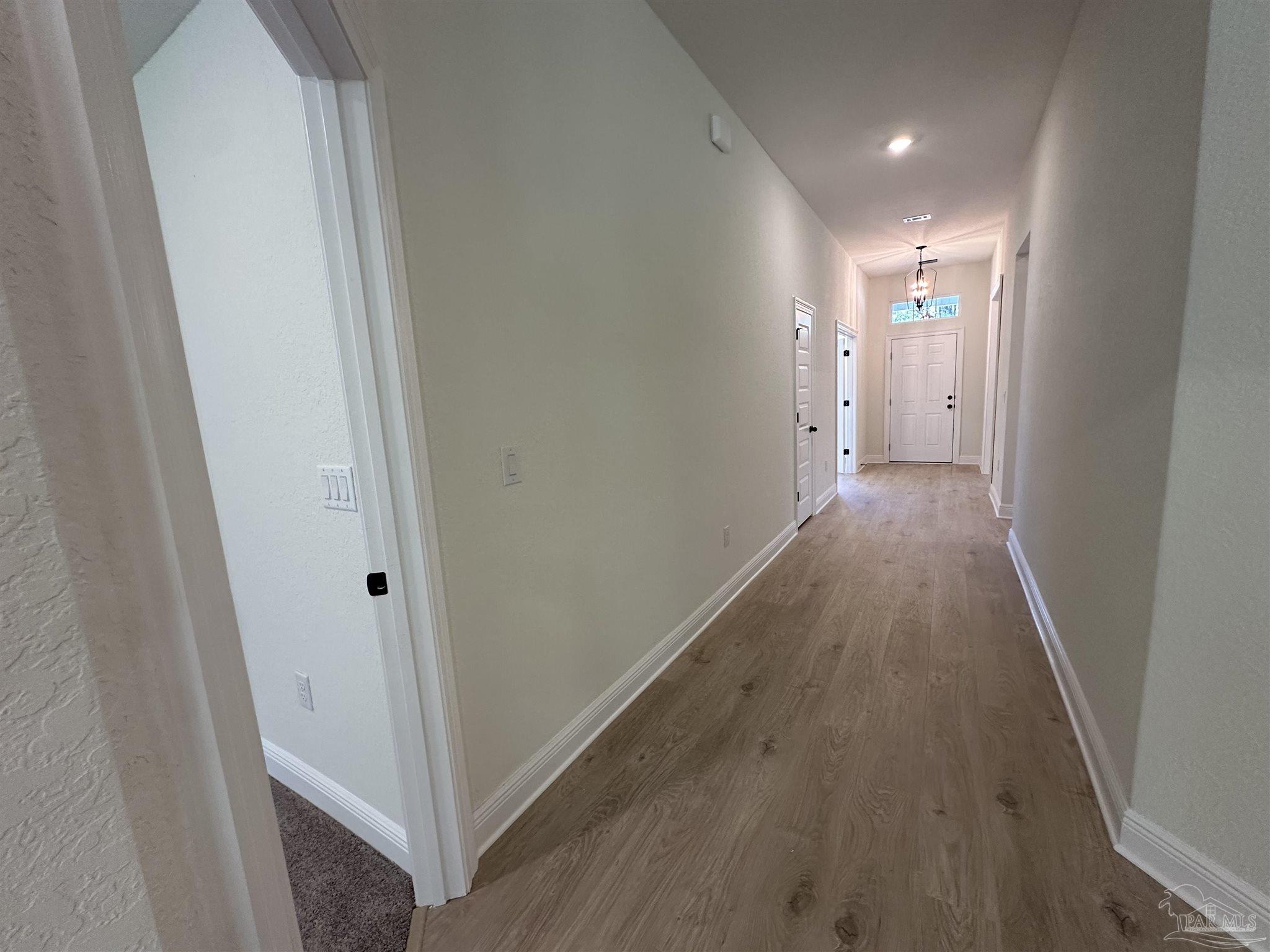 5223 Wahoo Road Milton, FL 32583 - Photo 24 of 26 a view of a hallway with wooden floor