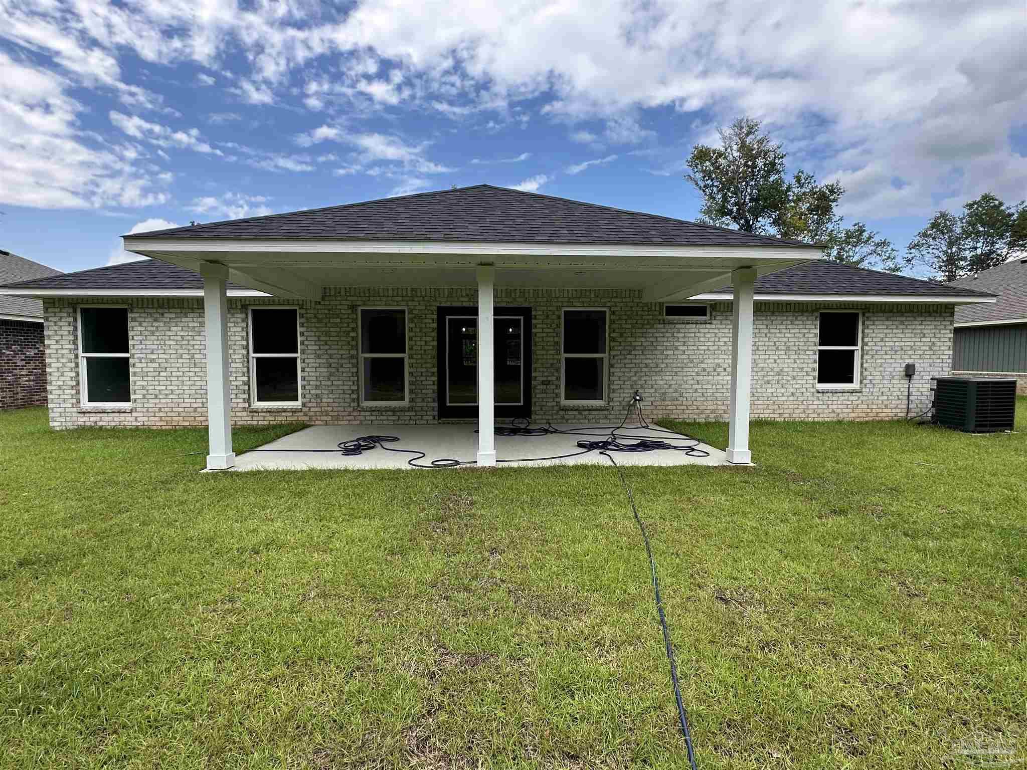 5223 Wahoo Road Milton, FL 32583 - Photo 26 of 26 a view of a house with swimming pool and a yard