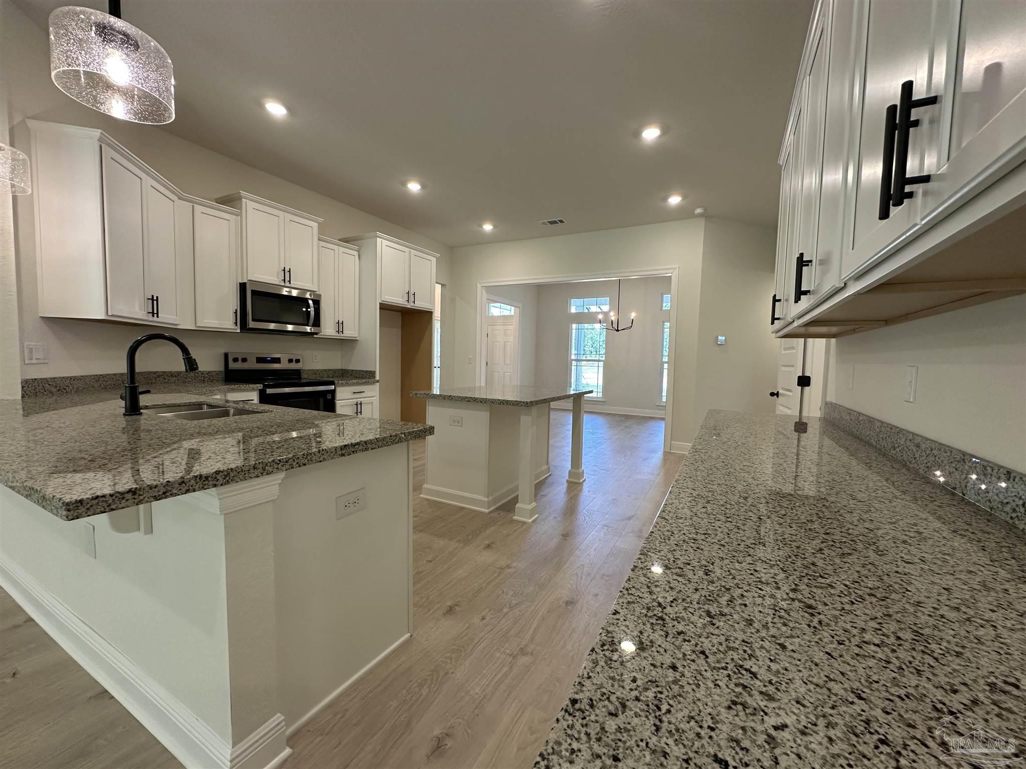 5223 Wahoo Road Milton, FL 32583 - Photo 6 of 26 a view of kitchen with sink microwave and refrigerator