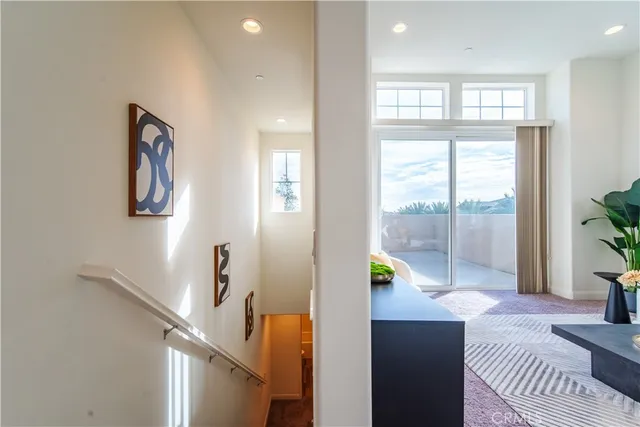 a living room with furniture potted plant and windows
