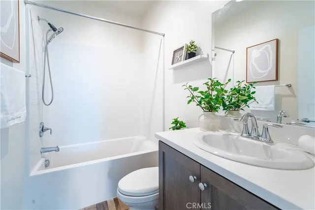 a kitchen with stainless steel appliances granite countertop a sink and a refrigerator