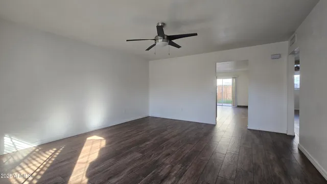 wooden floor in an empty room with a window