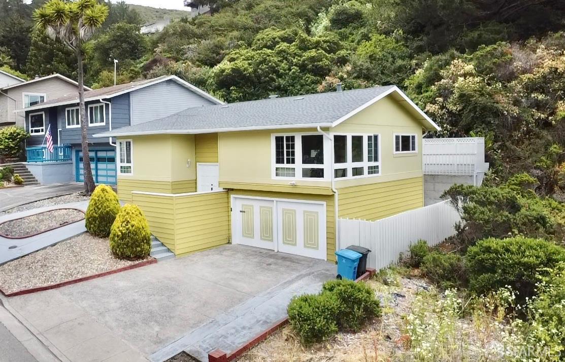 949 Yosemite Drive Pacifica, CA 94044 - Photo 1 of 2 a front view of a house with a yard and garage