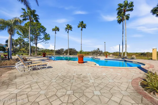 a view of a swimming pool with a yard