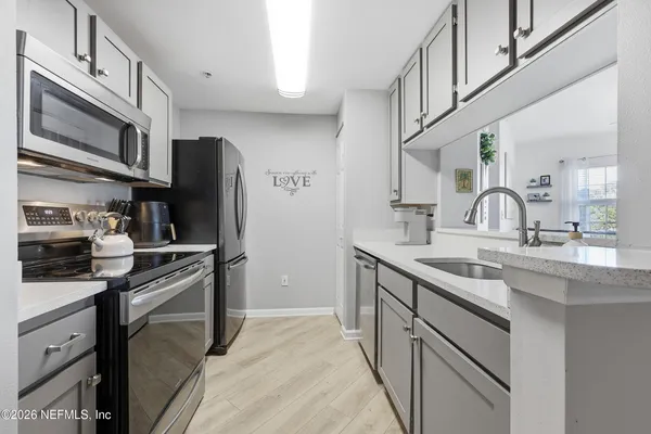 a kitchen with cabinets and chairs