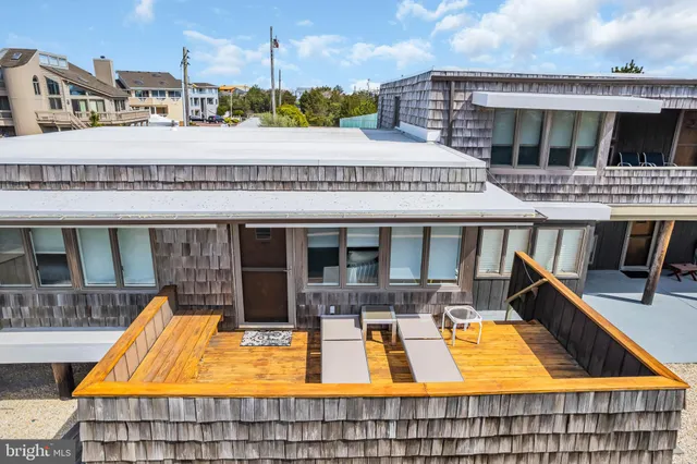 an aerial view of a house with a garden and lake view