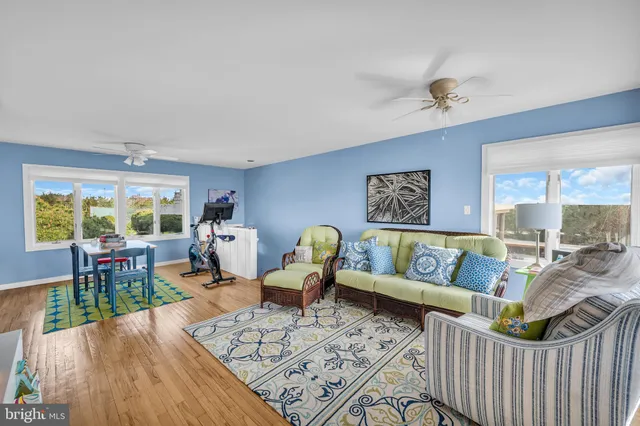 a bedroom with furniture and large windows