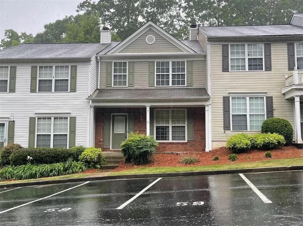 9155 Nesbit Ferry Road, Unit 59 Alpharetta, GA 30022 - Photo 1 of 1 front view of a house with a yard