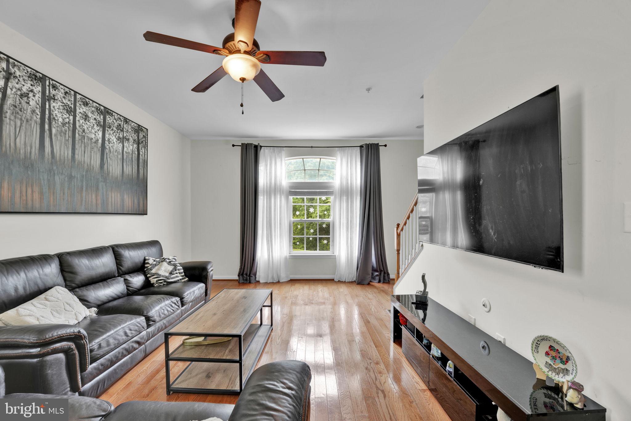 7138 Station House Road Elkridge, MD 21075 - Photo 20 of 42 a living room with furniture and a flat screen tv