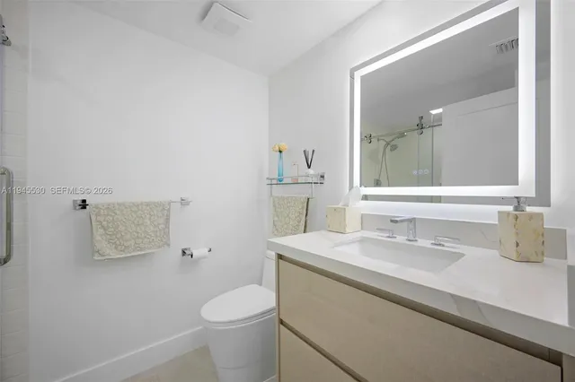 a bathroom with a sink toilet and mirror