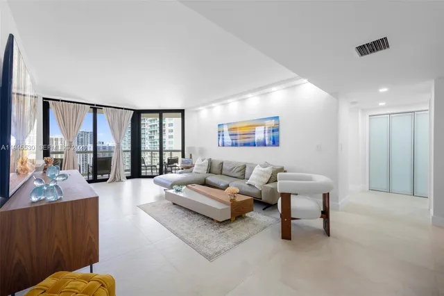 a living room with furniture and a large window