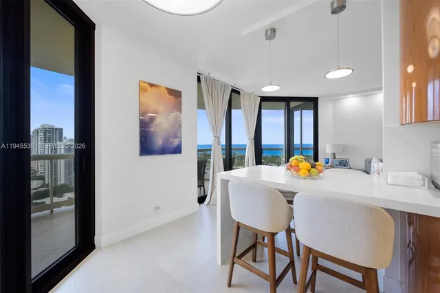 a view of a dining room with furniture and a potted plant