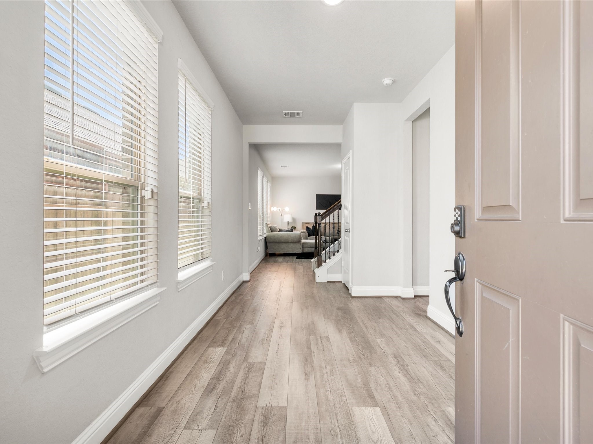 7123 Poppyseed Trail Spring, TX 77379 - Photo 5 of 30 A bright, welcoming entry showcases large windows, durable vinyl plank flooring, and deep baseboards that add a polished touch from the moment you arrive.