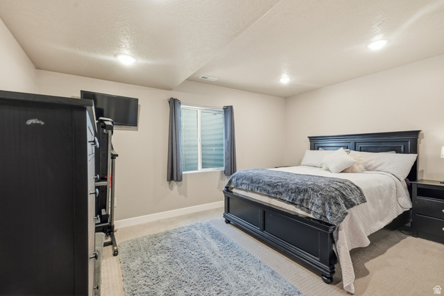 3244 West 1670th Street North Provo, UT 84601 - Photo 43 of 56 Neutral-toned walls complement carpet flooring throughout this room, featuring a window with privacy blinds and recessed lighting