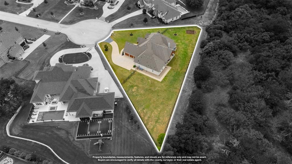 1060 Waters Edge Court Oak Point, TX 75068 - Photo 39 of 40 an aerial view of a house with a swimming pool