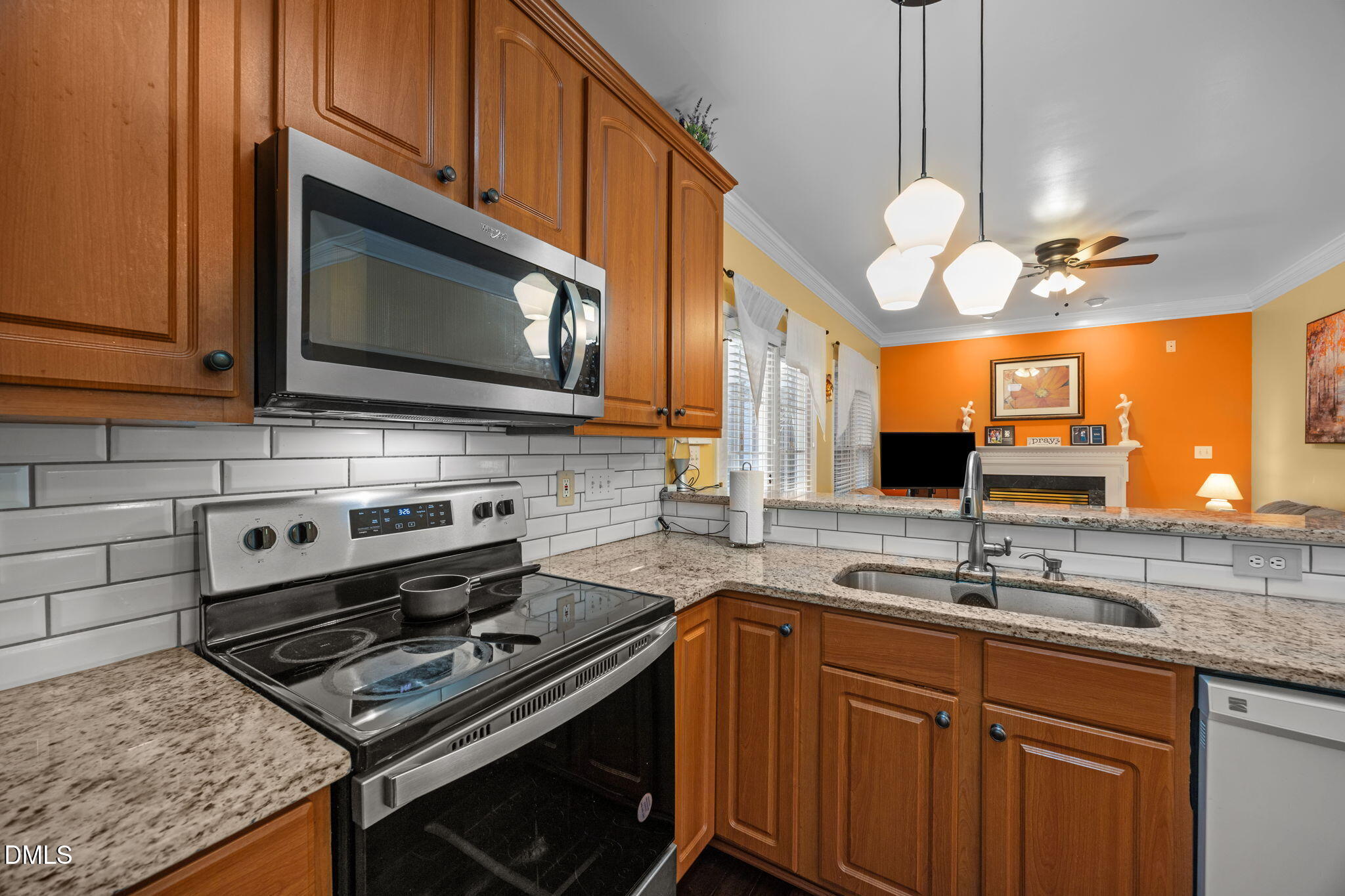 1758 Rowsby Court Wake Forest, NC 27587 - Photo 12 of 48 a kitchen with stainless steel appliances a stove a sink and a microwave