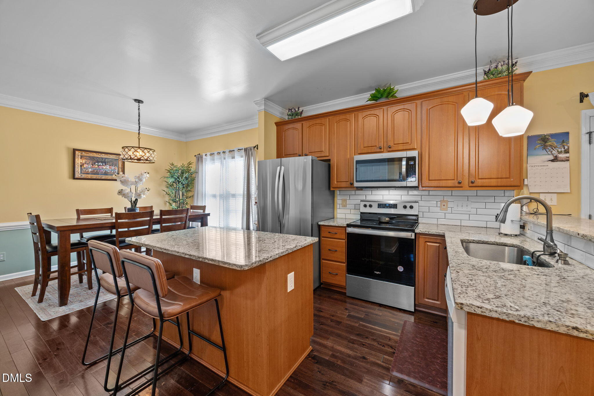 1758 Rowsby Court Wake Forest, NC 27587 - Photo 13 of 48 a kitchen with stainless steel appliances granite countertop a sink a stove a refrigerator cabinets and chairs