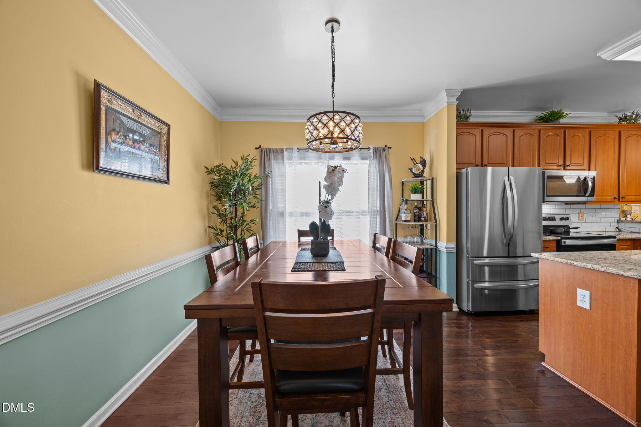1758 Rowsby Court Wake Forest, NC 27587 - Photo 7 of 48 a dining room with furniture a chandelier and wooden floor