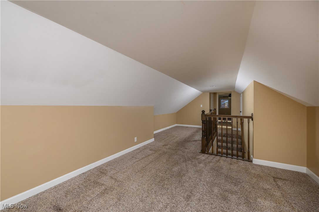 1320 Perry Drive Northwest Canton, OH 44708 - Photo 25 of 34 Additional living space featuring vaulted ceiling and carpet floors