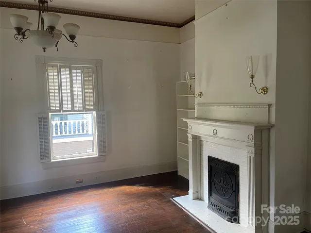 a view of a livingroom with a fireplace and window