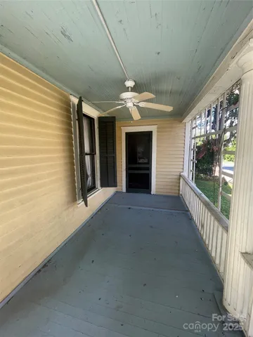 a view of a livingroom with a fireplace hallway and a mirror