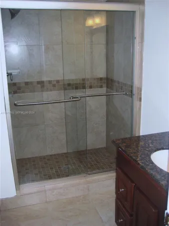 a bathroom with a shower and vanity