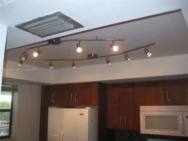 a kitchen with a sink and a refrigerator