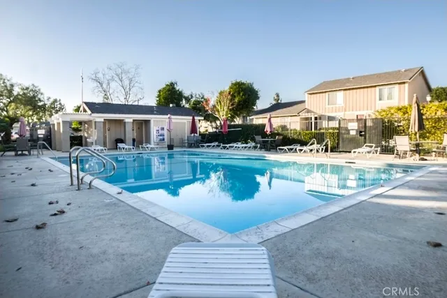 a swimming pool view with a outdoor seating