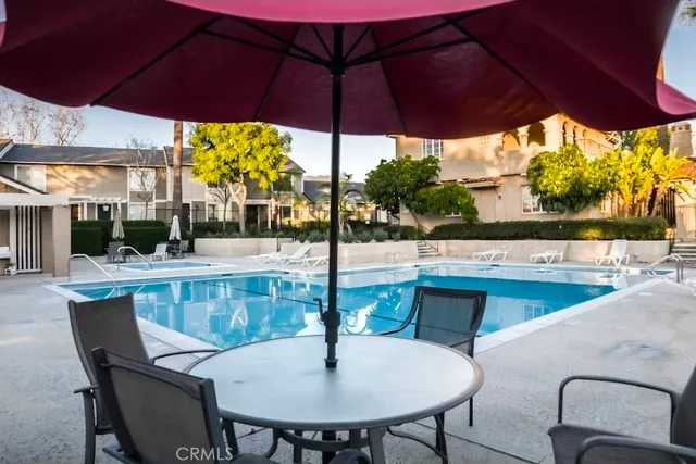 a view of a patio with a table and chairs under an umbrella