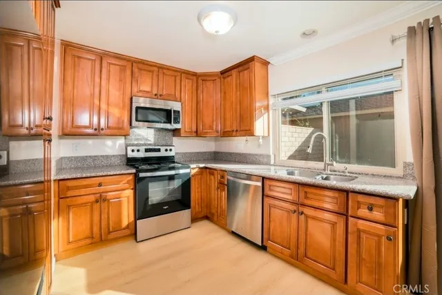 a kitchen with granite countertop a stove sink and microwave