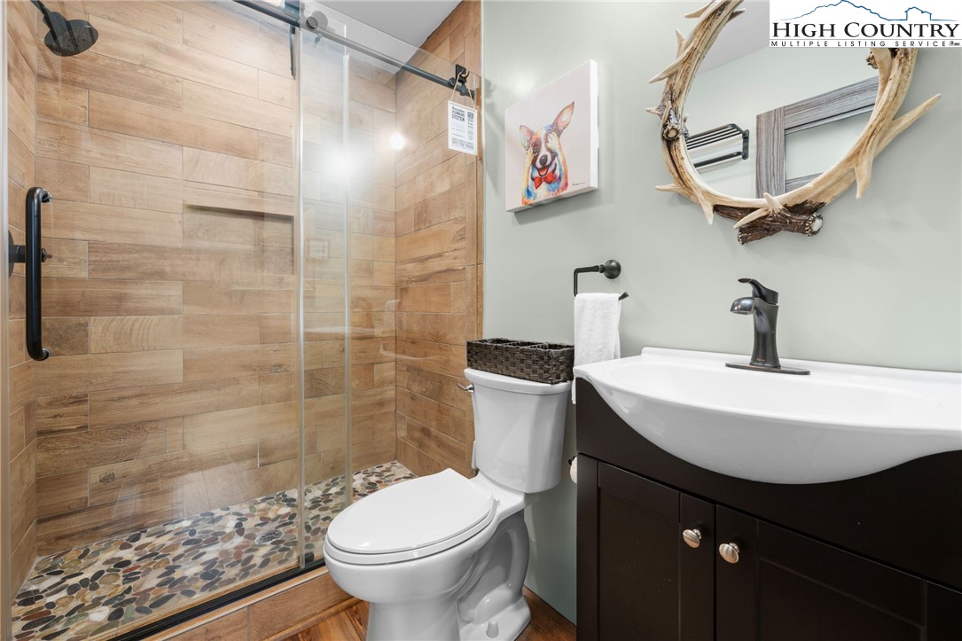 123 St Andrews Road Beech Mountain, NC 28604 - Photo 39 of 50 a bathroom with a sink a toilet and shower