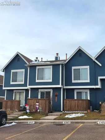 a front view of a house with a road