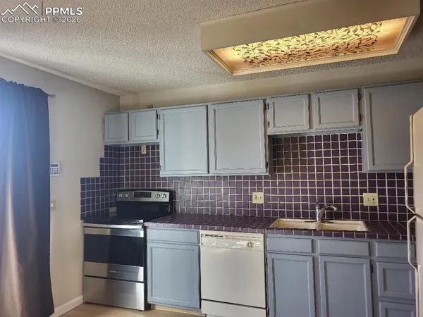 a kitchen with a stove and a refrigerator