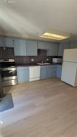 a kitchen with stainless steel appliances a stove and a refrigerator