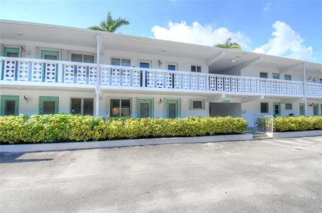 front view of a brick house with a yard