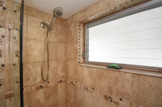 a view of a house with a yard and potted plants