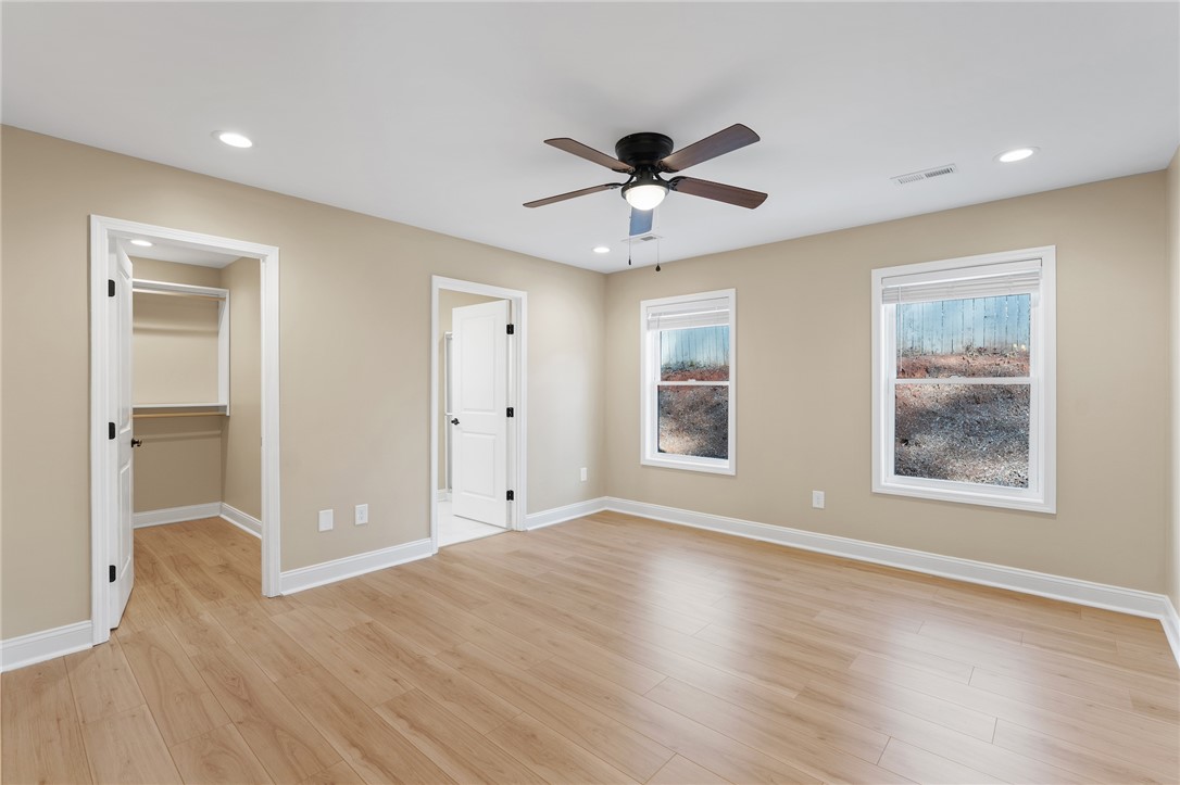 505 Hillside Drive Walhalla, SC 29691 - Photo 15 of 31 This airy bedroom offers abundant light, a spacious closet, and a private en-suite bathroom.
