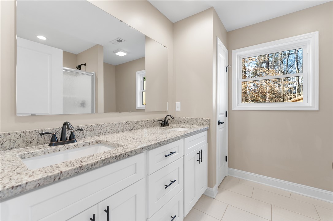 505 Hillside Drive Walhalla, SC 29691 - Photo 17 of 31 This bathroom features a double vanity with granite counters and a large window providing ample natural light.